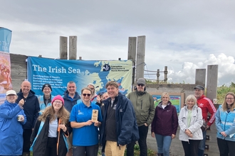 Dr Tom Burditt presents the award to The Bay volunteers