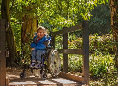 A child in a wheelchair visiting an accessible nature reserve