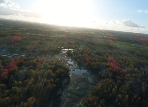 Drone view of Wigan Flashes nature reserve with sun flare