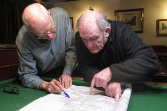 Mike Fisher of the GPAG looking over documents with a colleague