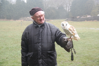 John Anderton holding a barn owl