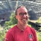 A smiling man in a greenhouse