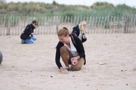 Clare helping with a nurdle hunt at Crosby beach