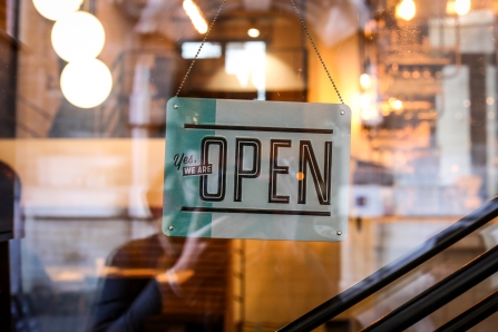 An open sign in the window of a shop