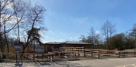 Mere Sands Wood visitor centre featuring the newly built access bridge against a blue sky