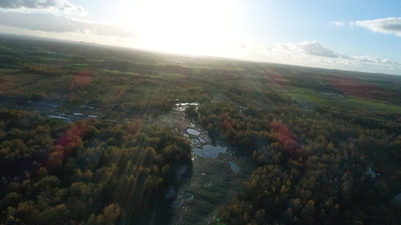 Drone view of Wigan Flashes nature reserve with sun flare