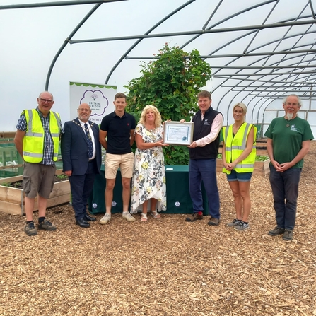 Award for meeting biodiversity benchmark handed to Blackburn Farm by Craig Bennett