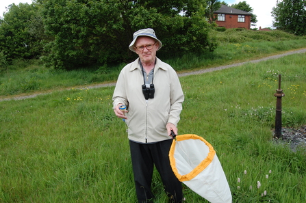 John Anderton holding an insect net