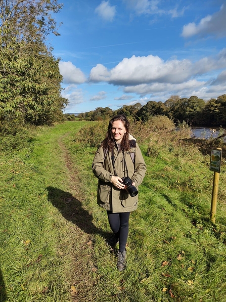 Laura holding a camera at Brockholes on a path 