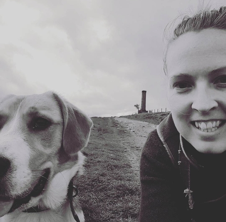 A woman and her dog in black and white