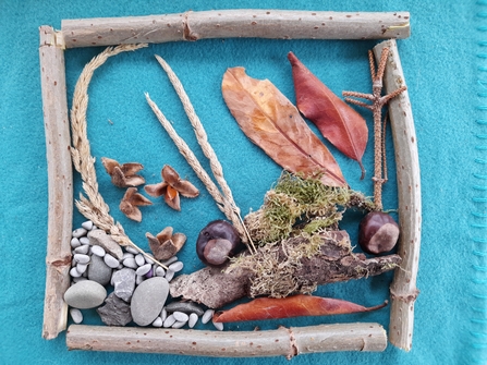 Natural art made using pebbles, leaves, conkers and sticks