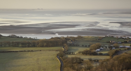 A sweeping view over open fields to Morecambe Bay from Arnside Knott