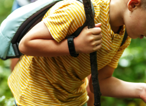 Child using a magnifying glass to look at wildlife