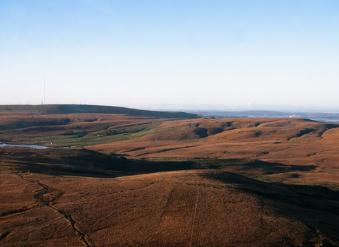 A beautiful moorland with small bodies of water and a blue sky