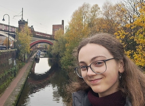 Amy on a bridge over a river canal.